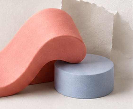 Coral clay wave resting on a powder blue disc